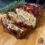 Close-up of sliced Cheesy Stuffed Meatloaf Bites with melted cheese filling and a glazed topping.