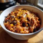 A delicious Chicken Enchilada Bowl filled with shredded chicken, corn, black beans, and melted cheese.