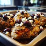 Close-up of baked Chicken with Olives and Feta, seasoned and ready to eat.