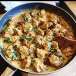 Delicious Marry Me Chicken in a creamy sauce with sun-dried tomatoes and herbs, served in a skillet.