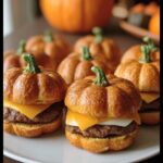 Delicious Pumpkin-Shaped Sliders Halloween. Close-up of sliders shaped like pumpkins, with cheese and burger patty.
