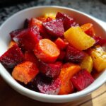 Close-up of a bowl of Roasted Beets and Carrots Salad, featuring vibrant colors and textures.