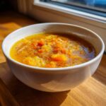 A bowl of vibrant Roasted Winter Vegetable Soup, showcasing chunks of vegetables in a flavorful broth.