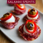 Close-up of Salami Mozzarella Eyeballs, a spooky Halloween recipe with salami, mozzarella, olive, and red pepper.