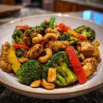 A colorful bowl of Sheet Pan Cashew Chicken with broccoli, peppers, and cashews.