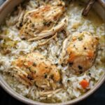 Overhead view of Slow Cooker Chicken and Rice in a bowl, featuring chicken thighs and white rice.