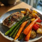Baked fish with roasted vegetables, including asparagus, carrots, potatoes, and cauliflower. Part of Ultimate Easy Dinner Recipes Guide.
