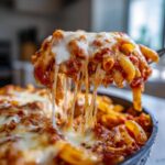Close-up of cheesy baked pasta being lifted, showcasing the delicious Pasta Recipes Recipe Everyone Asks For.