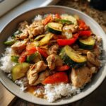 Chicken stir-fry with rice, zucchini, and red peppers. Part of our Ultimate Dinner Ideas Guide.