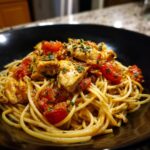 A bowl of spaghetti topped with diced chicken and fresh tomato sauce, showcasing easy dinner recipes.