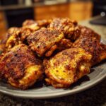 A plate of golden-brown, crispy chicken thighs, perfect for Chicken Thigh Recipes for Busy Weeknights.