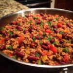 Hearty chili with ground beef, kidney beans, peppers, and tomatoes, a great dinner ideas option.