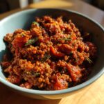 Bowl of delicious ground beef recipes recipe everyone asks for, with tomatoes and herbs.