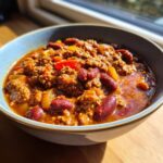 Bowl of hearty chili, a perfect Dinner Recipes Recipe Everyone Asks For, featuring beans, ground meat, and colorful peppers.