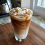 Iced caramel macchiato with whipped cream and caramel drizzle, perfect for learning How to Make Starbucks Drinks.