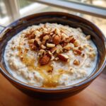 Bowl of oatmeal topped with almonds and honey, a quick breakfast idea in 20 minutes.