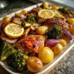 A delicious and easy One-Pan Dinner Ideas featuring roasted chicken, potatoes, broccoli, red onions, and lemon slices.