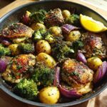 A delicious One-Pan Easy Dinner Recipe featuring roasted chicken, potatoes, broccoli, and red onions.