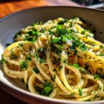 Close-up of One-Pan Pasta Recipes dish with spaghetti, herbs, and parmesan cheese in a bowl.