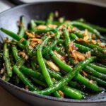 Close-up of One-Pan Thanksgiving Green Beans with toasted almonds in a skillet.