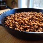 Cooked ground beef in a cast iron skillet, showcasing what makes perfect ground beef recipes.