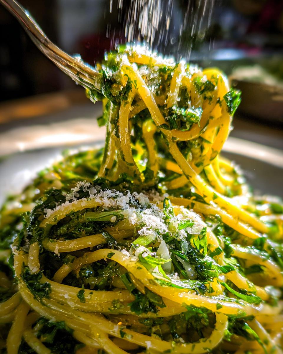 Close-up of pasta with herbs and cheese being sprinkled on top, showcasing What Makes Perfect Pasta Recipes? Try This.