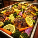 Sheet pan chicken with broccoli, carrots, red onion, and lemon slices, perfect for Dinner Recipes for Busy Weeknights.