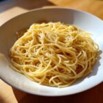 A bowl of spaghetti with butter and pepper, showcasing a simple pasta recipe.