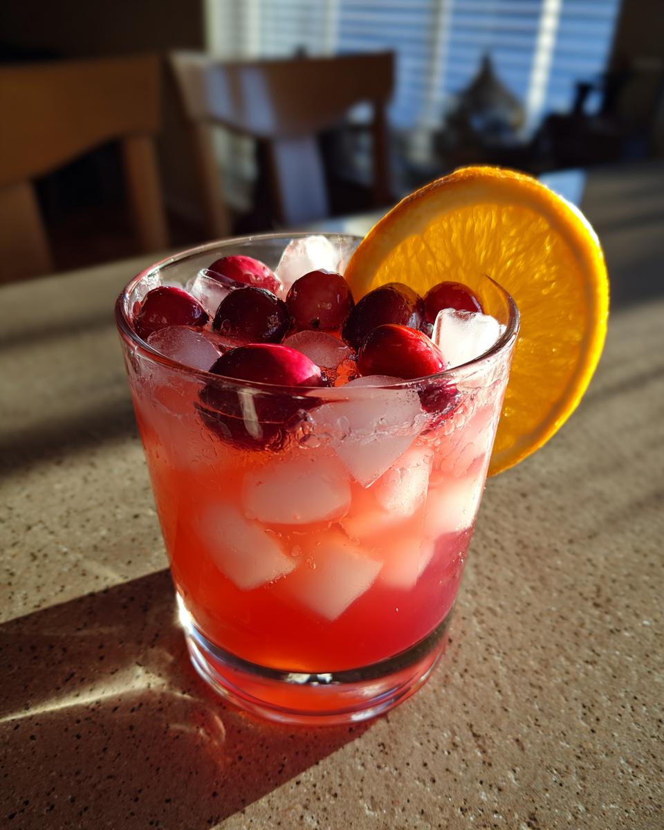 A refreshing Thanksgiving drink in 20 minutes, garnished with cranberries and an orange slice.