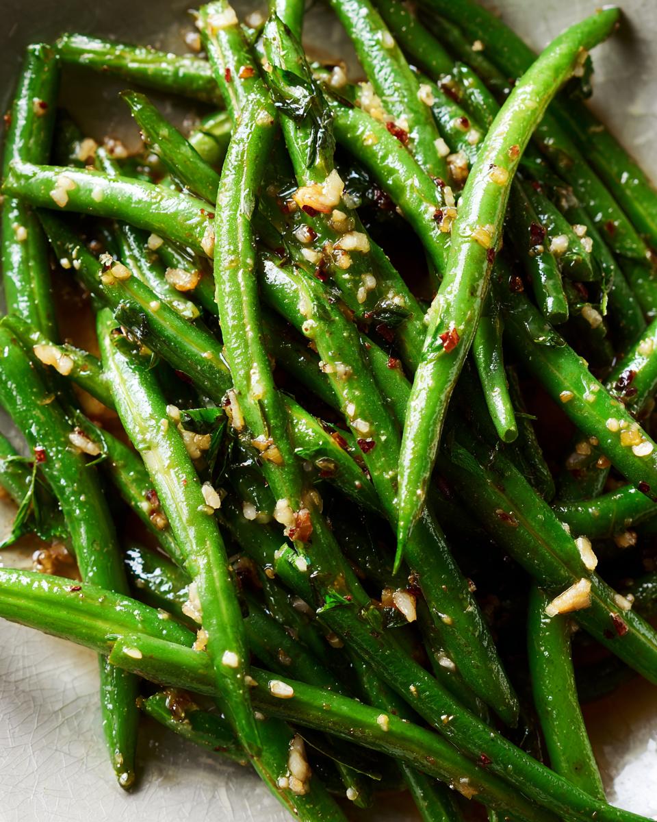 Close-up of Thanksgiving Green Beans in 20 Minutes, featuring garlic and red pepper flakes.