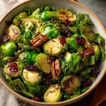 A vibrant Thanksgiving Salad featuring crispy Brussels sprouts, cranberries, and pecans.