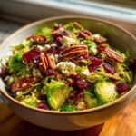 A vibrant Thanksgiving Salad Recipes Recipe Everyone Asks For, featuring brussel sprouts, cranberries, pecans, and feta.