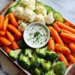 Colorful 5-Ingredient Thanksgiving Veggie Tray with carrots, broccoli, cauliflower, cucumbers, and dip.