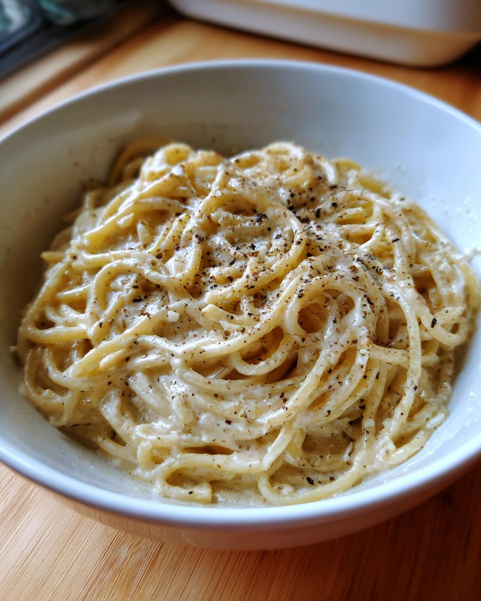 Close-up of One Pot Creamy Garlic Pasta coated in a rich sauce and topped with cracked black pepper.