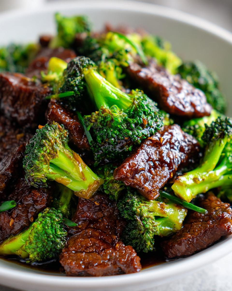 Close-up of tender beef slices coated in dark sauce mixed with vibrant green broccoli florets in a Simple Beef & Broccoli Stir Fry.