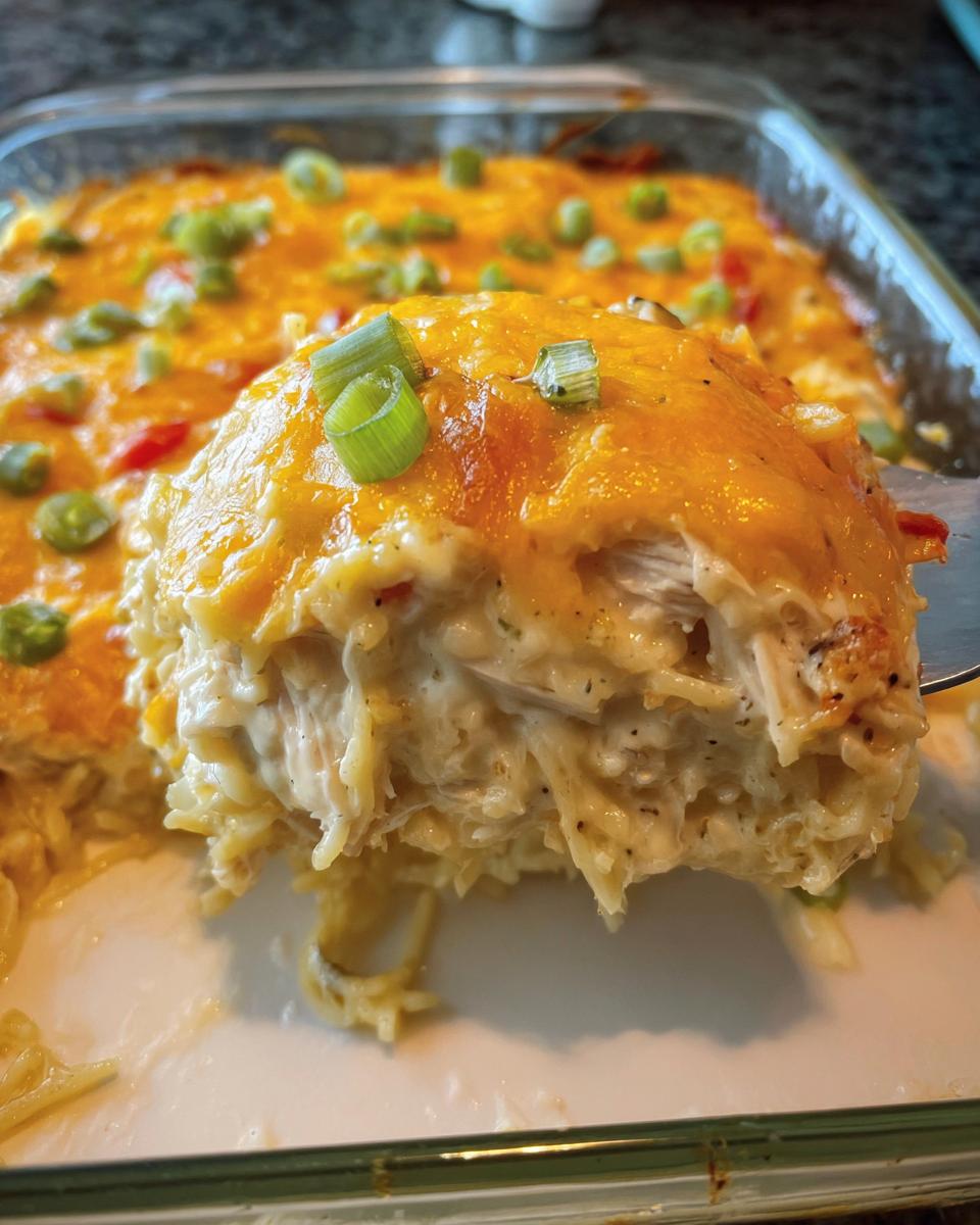 A scoop of creamy chicken and noodle casserole topped with melted cheddar and green onions, perfect for Healthy Family Dinners That Kids Enjoy.