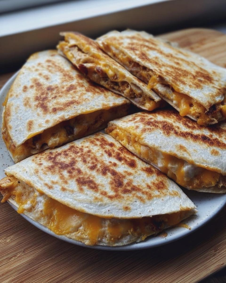 Four golden-brown quesadilla wedges filled with melted cheese, a great example of Healthy Meals You Can Prep in Under 1 Hour.